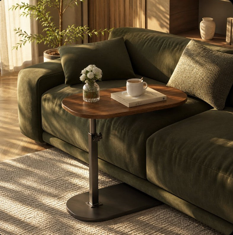 Order adjustable height C-shaped side table with walnut finish top and black metal base, shown next to a sofa.